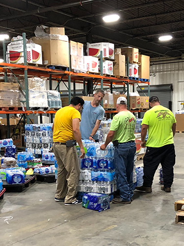 Helping with water at Hearts with Hands
